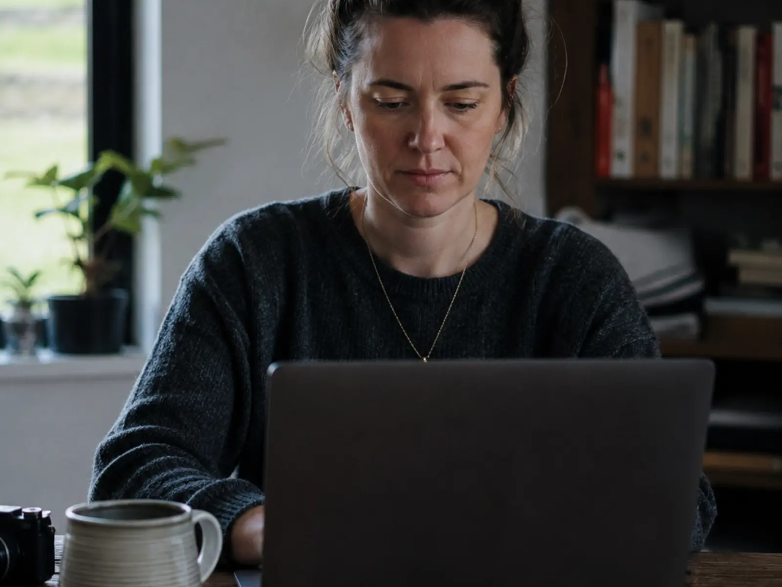 An Irish business owner updating their own website on a laptop