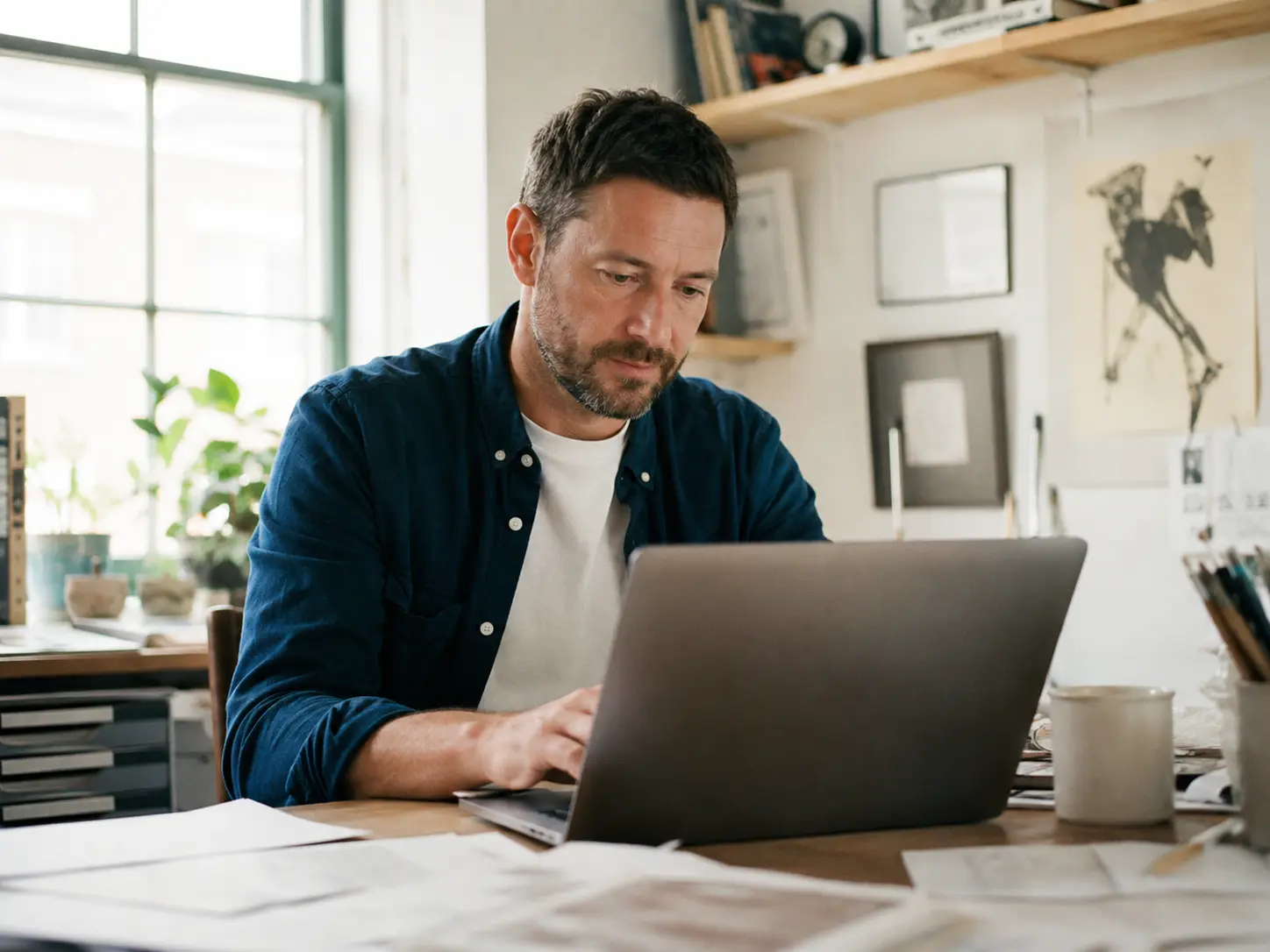 An Irish business owner reviewing a custom-built tool on a laptop