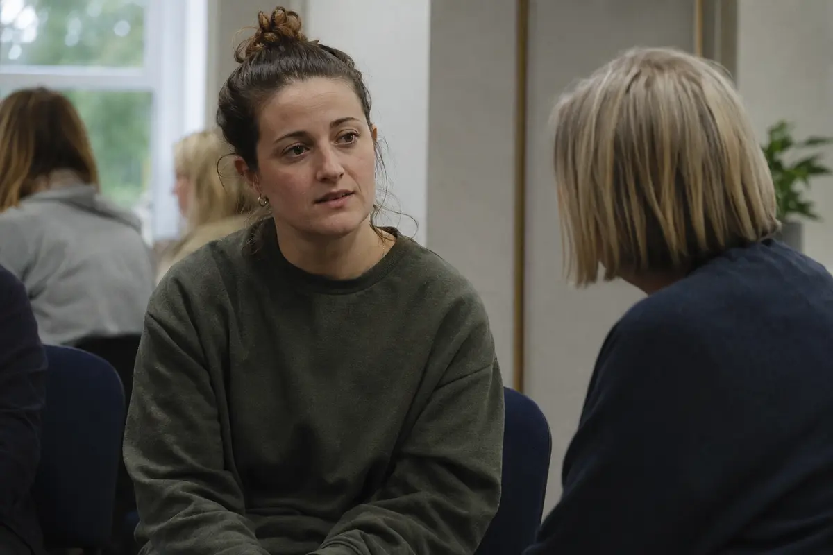 A peer-support group meeting in a community room