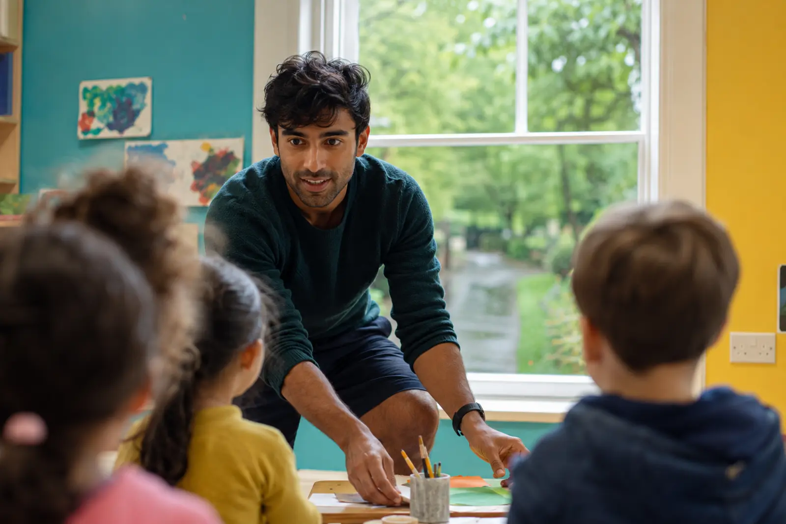 An early years educator doing a craft activity with young children at a table