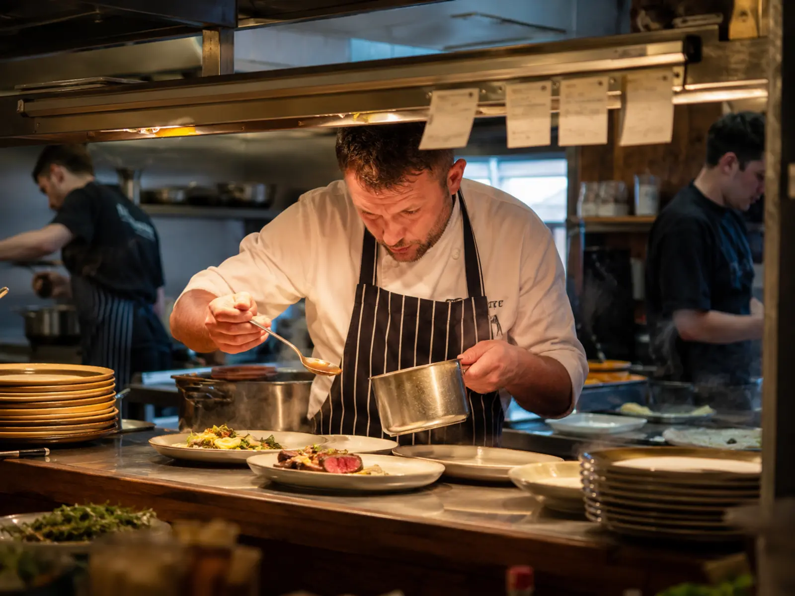 A busy Irish kitchen pass at service with order tickets